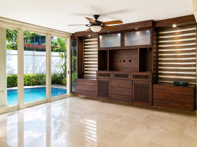 Spacious family room with natural light and direct access to private pool