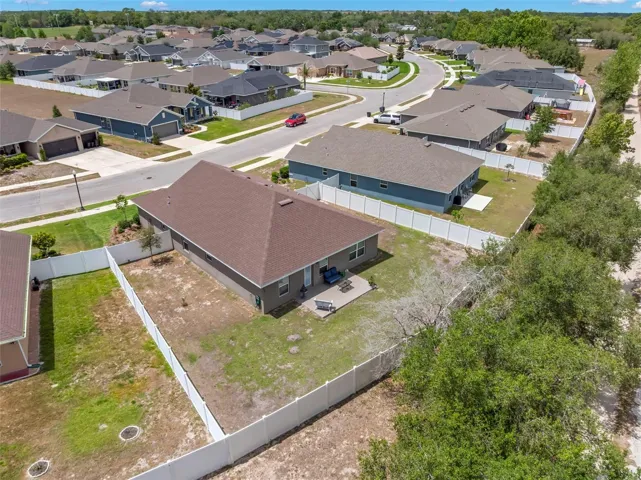 Privately situated against a wooded backdrop, the expansive fenced yard provides room to spread out and enjoy the outdoors.