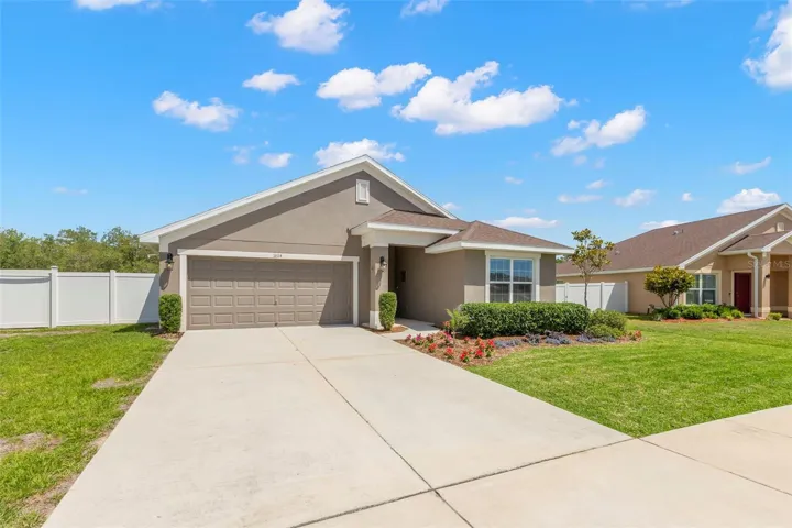 Additional bird’s-eye view showcases the home’s premium lot placement, expansive fenced yard, and private wooded backdrop.