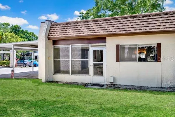 OUTSIDE VIEW OF SIDE AND CARPORT