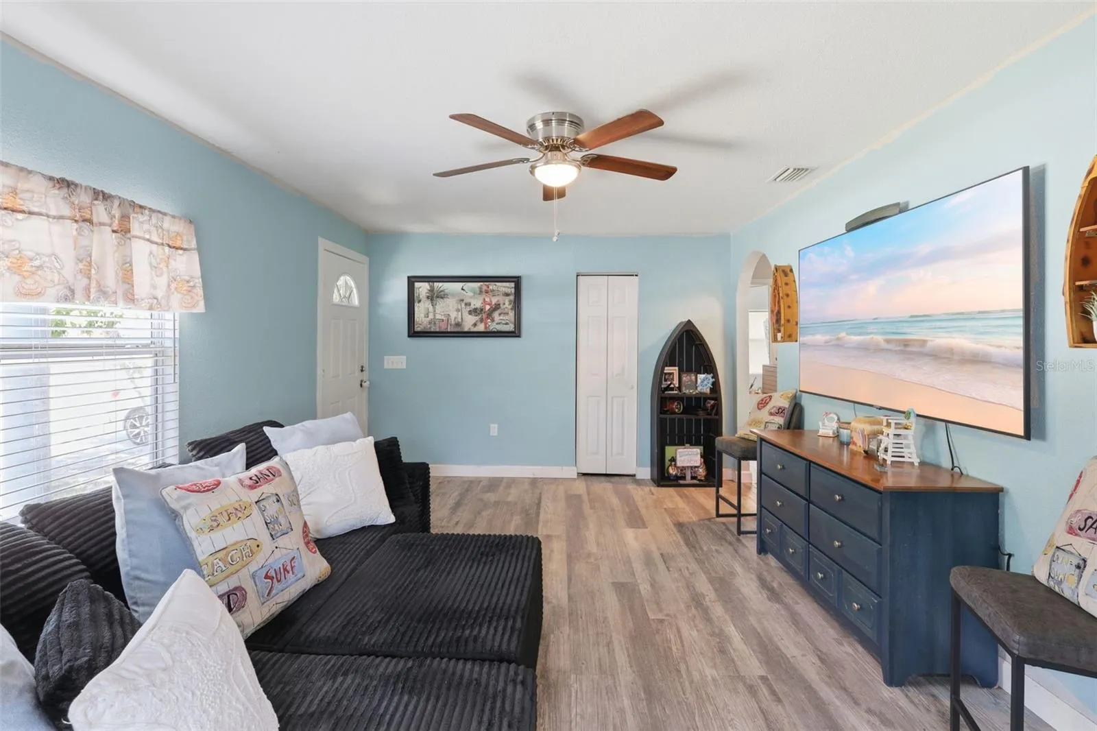 View of entrance, built in closet and living room area.