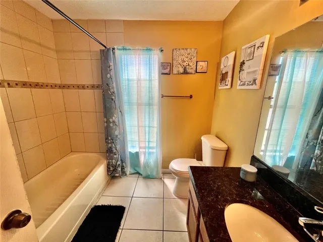 Hall Bathroom with Granite Counterops and beautiful tile