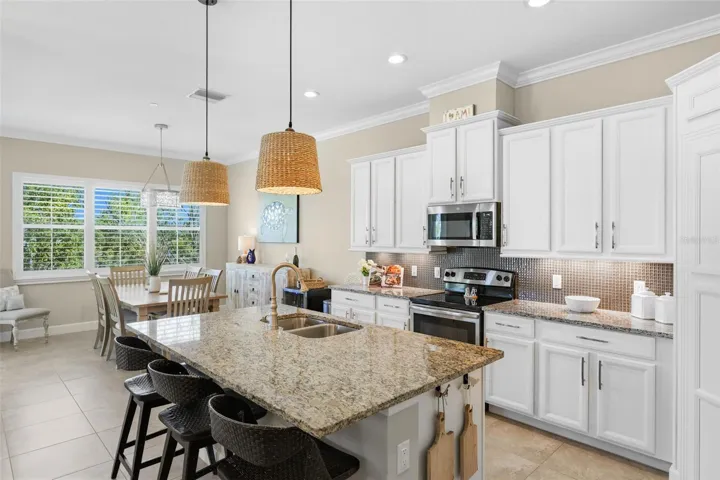 Spacious kitchen with granite counters, breakfast bar,