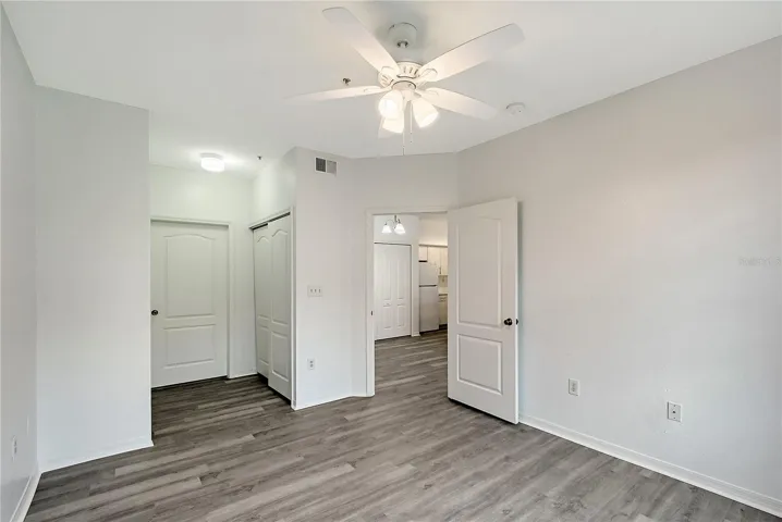Bedroom with double closets leading to bathroom ,looking into Dining Area and Kitchen