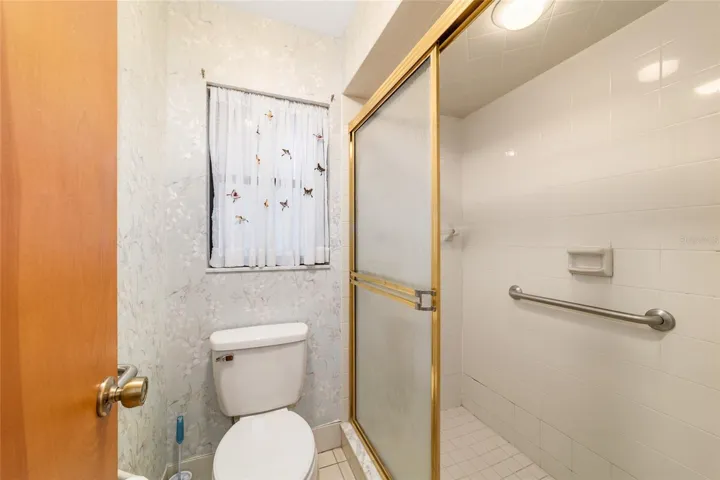 Primary ensuite with walk-in shower and walk-in closet with closet system