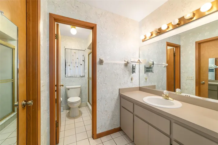 Primary ensuite with walk-in shower and walk-in closet with closet system