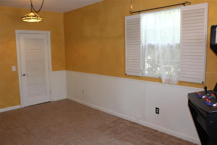 Bonus room area has tile flooring and storage closet.