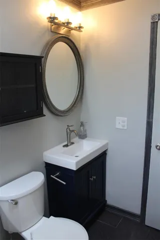 The main bathroom has everything remodeled: new toilet, new vanity, new cabinet, new mirror and light fixture!