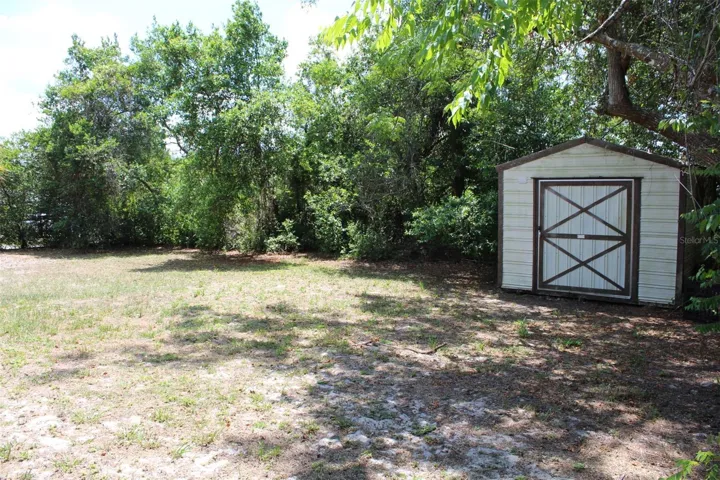 Large side yard with a photo of the yard shed.