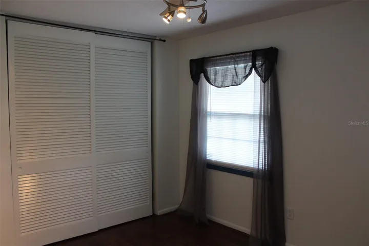 This is the second bedroom complete with two windows, a new light fixture and new flooring!