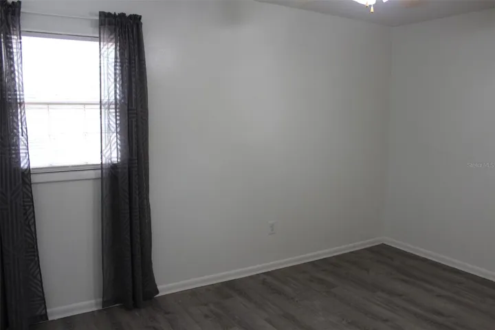 This is the primary bedroom with two windows, a built in closet and a half bathroom! Luxury Vinyl Plank flooring!