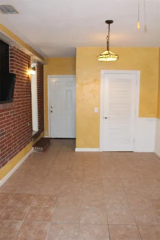 Bonus room that is off the kitchen has a storage closet and a door to the back yard.