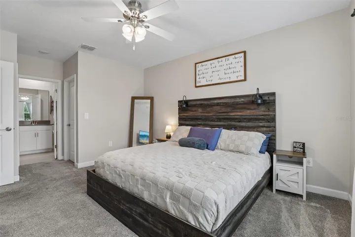 The Primary Suite serves as a peaceful sanctuary with plush carpeting, ABUNDANT NATURAL LIGHT, backyard views, dual closets, and a private EN SUITE BATH.