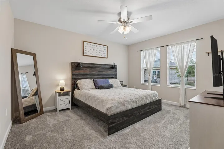 The Primary Suite serves as a peaceful sanctuary with plush carpeting, ABUNDANT NATURAL LIGHT, backyard views, dual closets, and a private EN SUITE BATH.