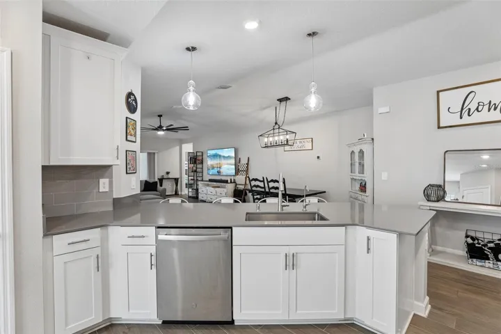 The heart of the home is the stunning Kitchen, thoughtfully designed with 42-inch white cabinetry, solid-surface countertops, stainless steel appliances, a stylish tile backsplash, closet pantry, UNDER-SINK REVERSE OSMOSIS SYSTEM (2024), and a charming breakfast nook.