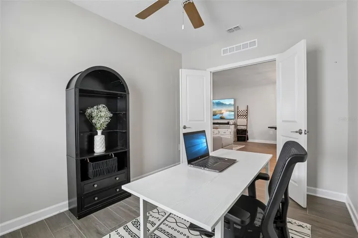 A DEDICATED OFFICE with French doors can easily serve as a fourth bedroom, hobby room, or study.