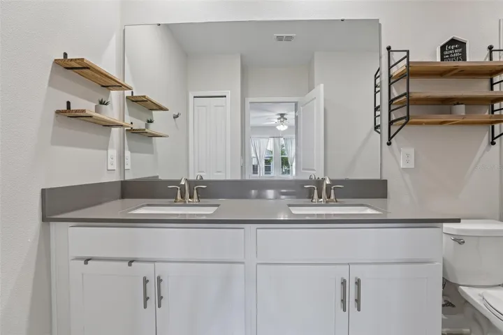 The private Primary EN SUITE BATH features dual sinks and a spacious step-in shower.