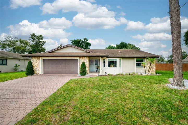Paver driveway welcoming you to this 3 bed pool home