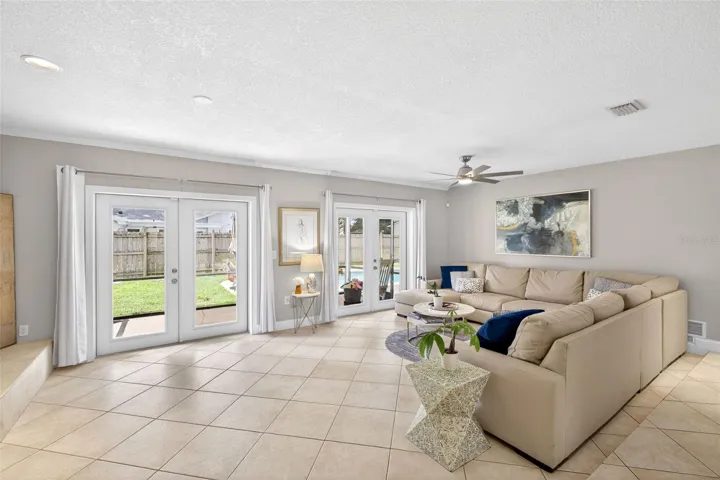 Light and bright living room with French doors to the covered and screened rear patio