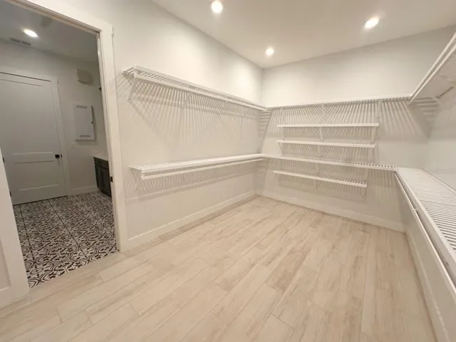 Primary walk-in closet connecting to laundry.