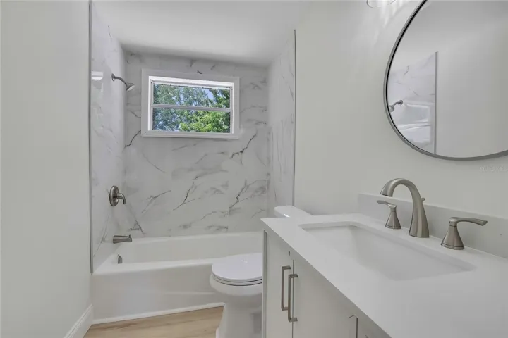 NEW TUB, NEW TILE, NEW TOILET, NEW HARDWARE/MIRROR AND NEW VANITY