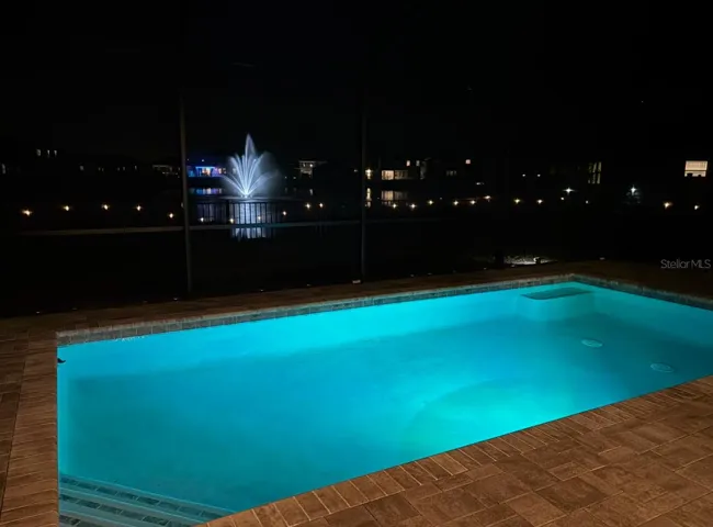 Pool at Night with Fountian on Pond