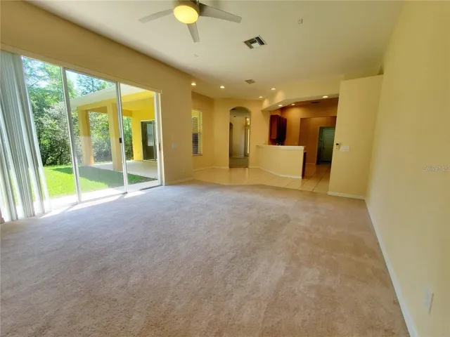 Large Family Room with Triple Sliding Doors and Conservation View