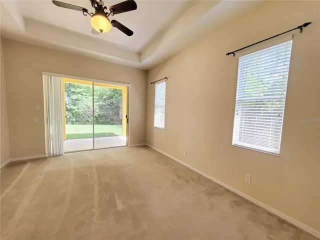 Large Primary Bedroom with Sliding Door to Patio and Conservation Views