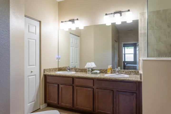 Double sinks and wooden cabinets
