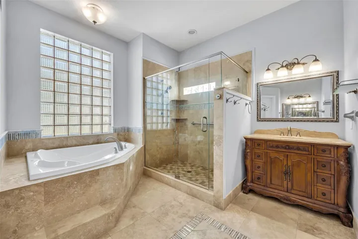 Primary bath with large soaking tub & glass shower