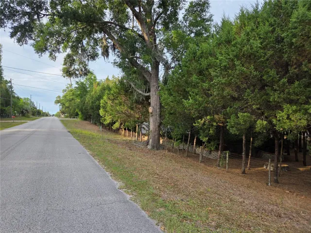 On a paved road corner lot