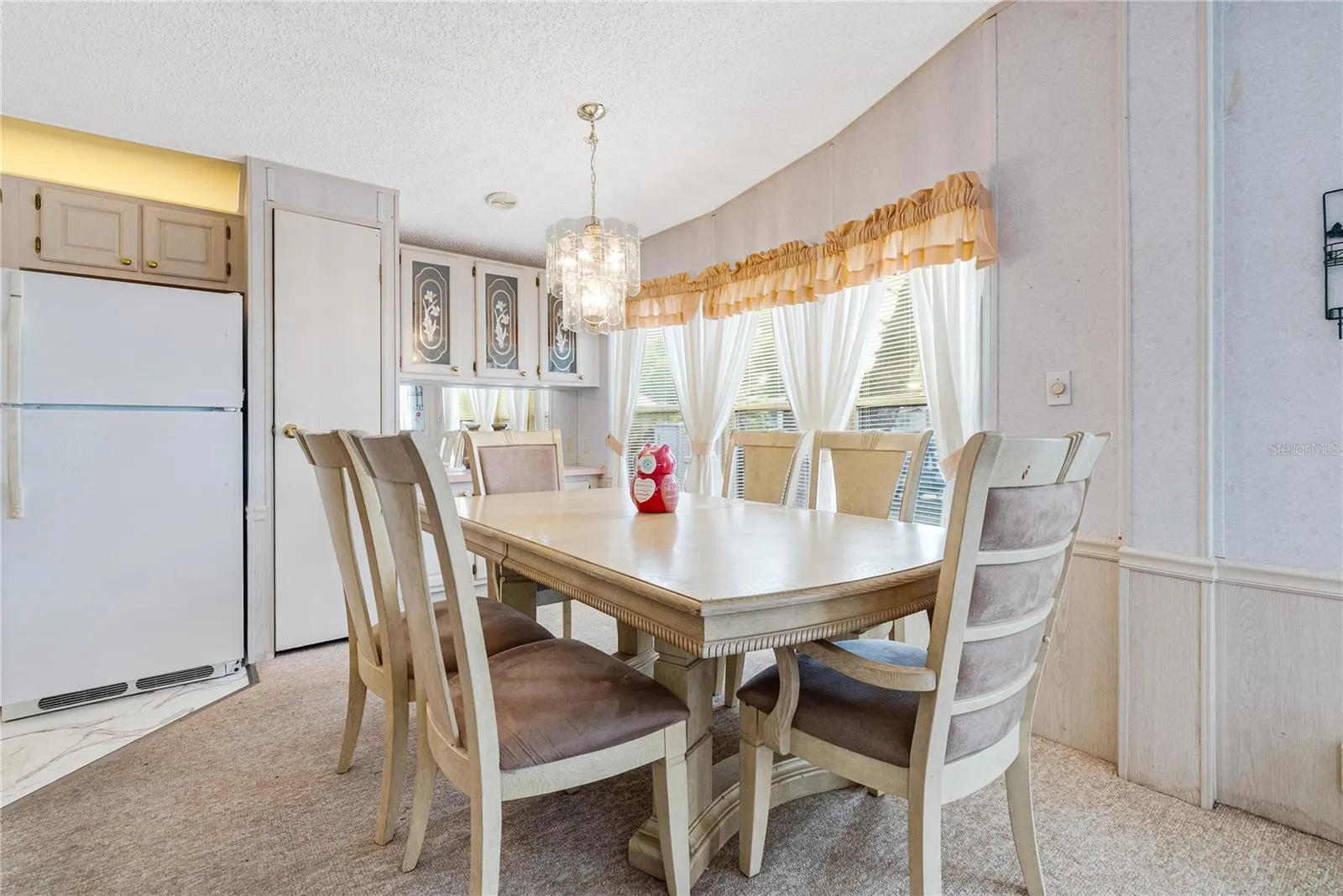 Spacious dining room with built in cabinetry sits alongside the kitchen and living room
