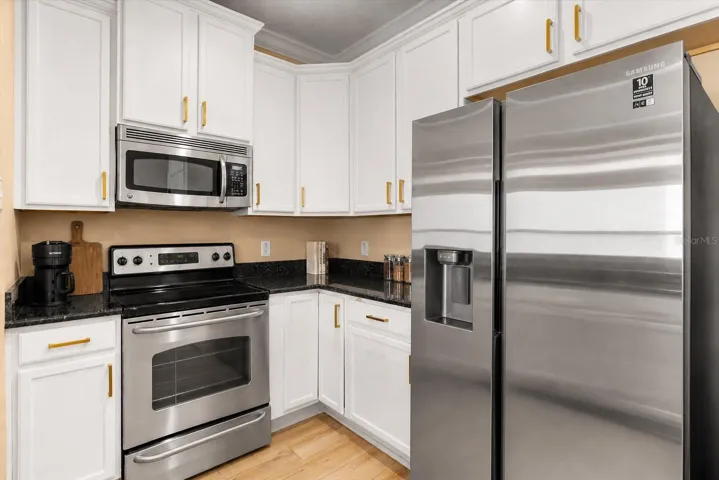 Functional kitchen with lots of cabinetry and workspace, perfect for cooking and gathering.