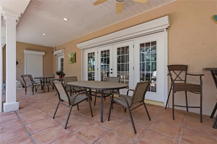 THE SPACIOUS SCREENED PORCH HAS NUMEROUS AREAS FOR SOCIALIZING