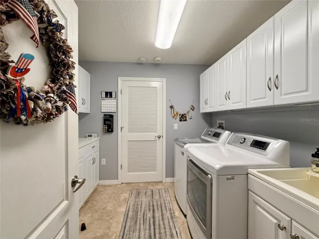 Laundry Room Has Sink And Cabinetry