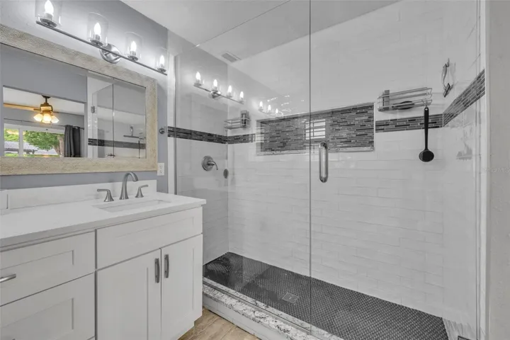 Primary bathroom features a glass-enclosed shower