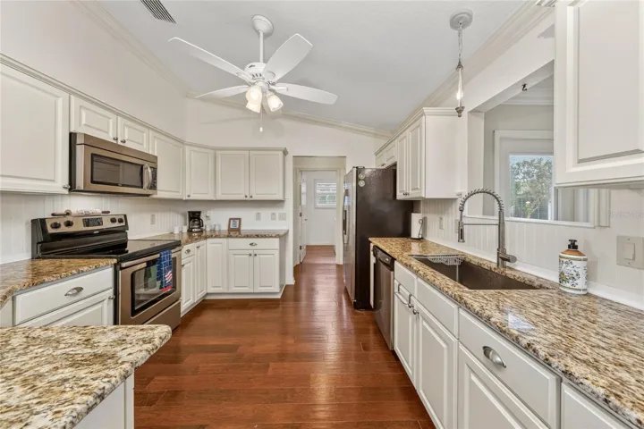 Kitchen with granite countertops, stainless appliances, pantry, and open layout