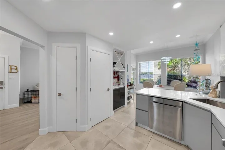master bathroom with glassed-in rainfall shower head. Floating vanity, linen closet.