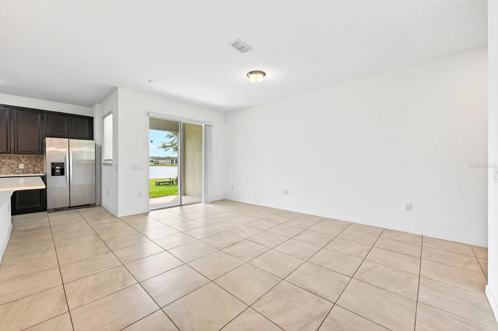 Living area has sliding glass doors that open up to the covered lanai.