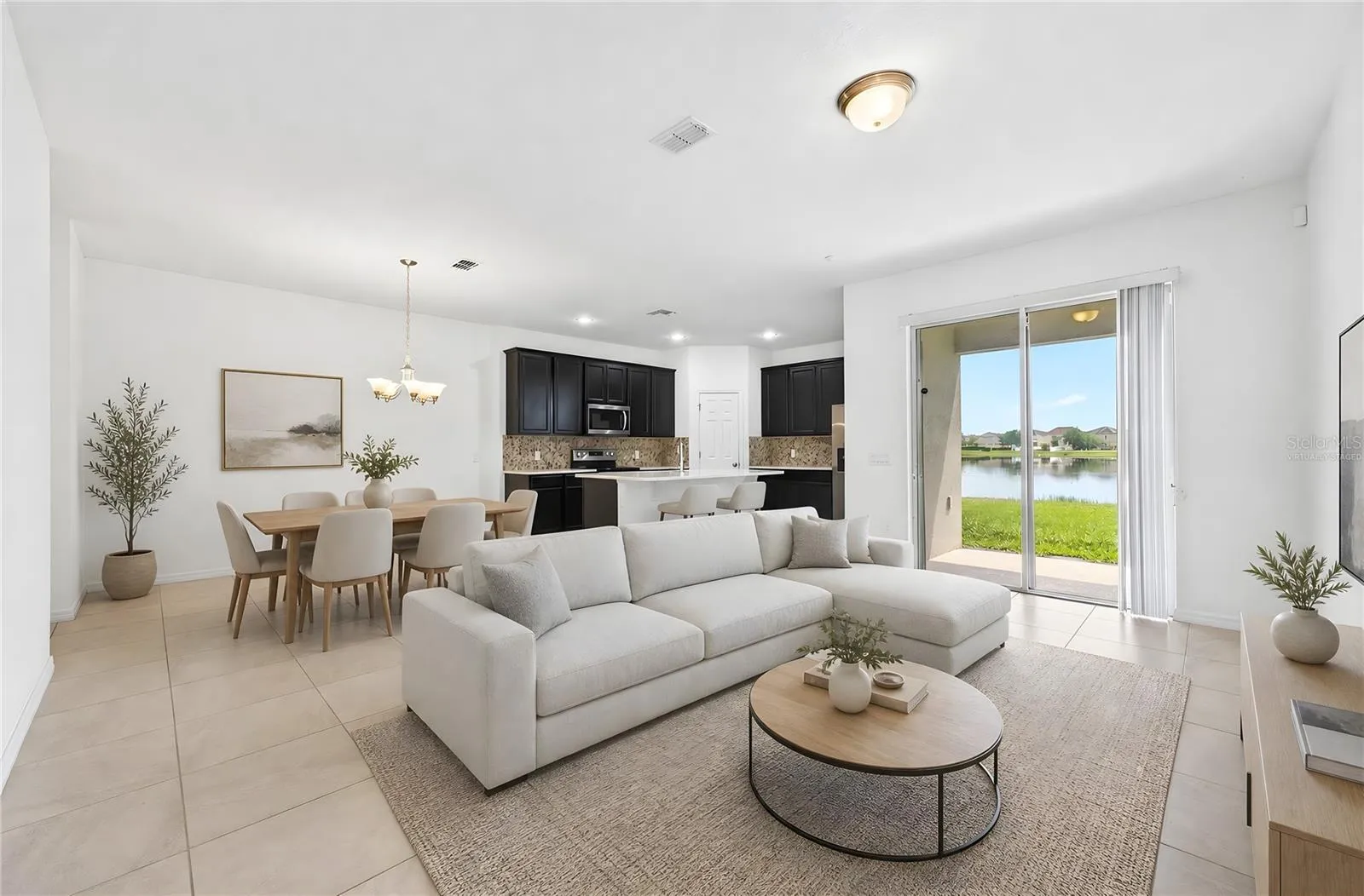 Light, bright open concept living and dining with tranquil pond views! Virtually Staged.