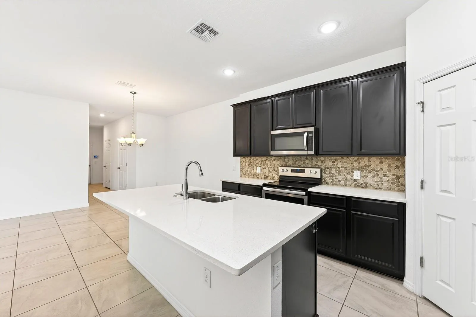 Large kitchen island has bar seating for casual dining or entertaining.