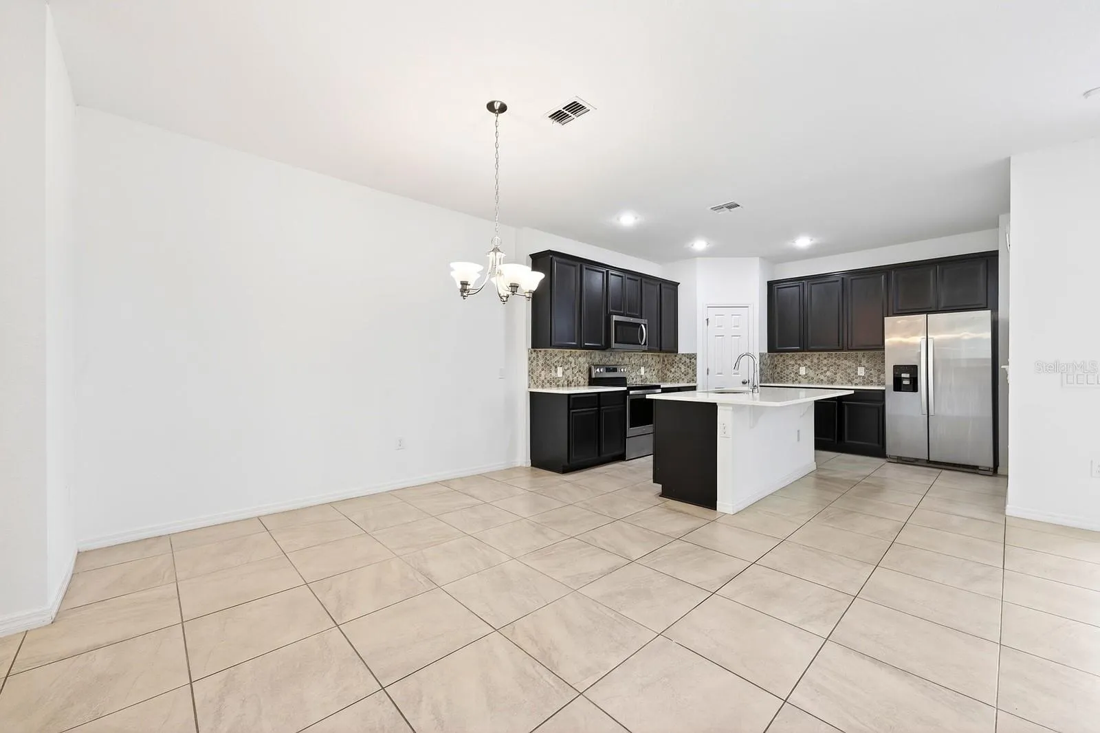 Kitchen is open to the living and dining areas.