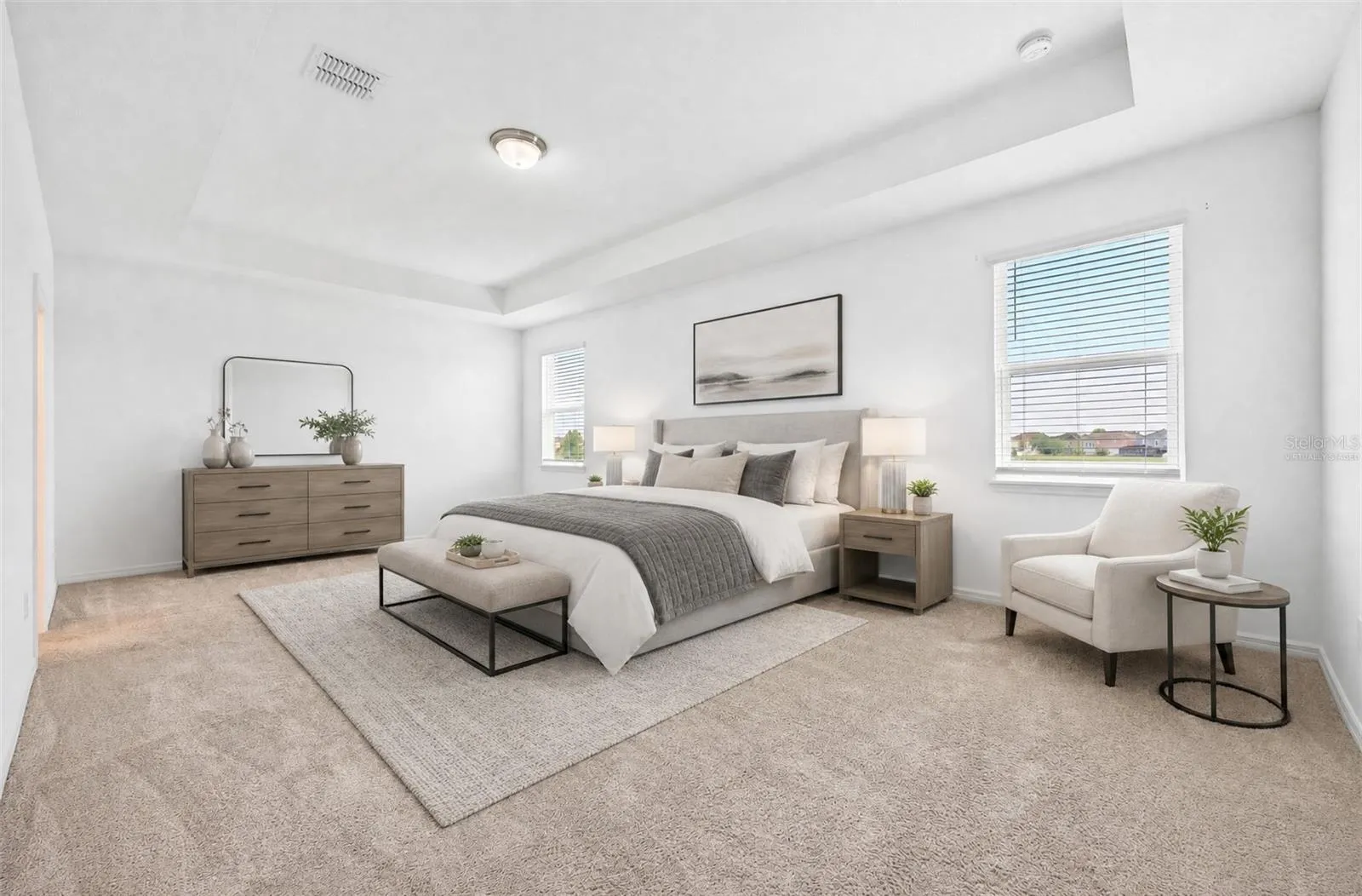 Generous primary suite features a tray ceiling, walk-in closet and private bath. Virtually Staged.