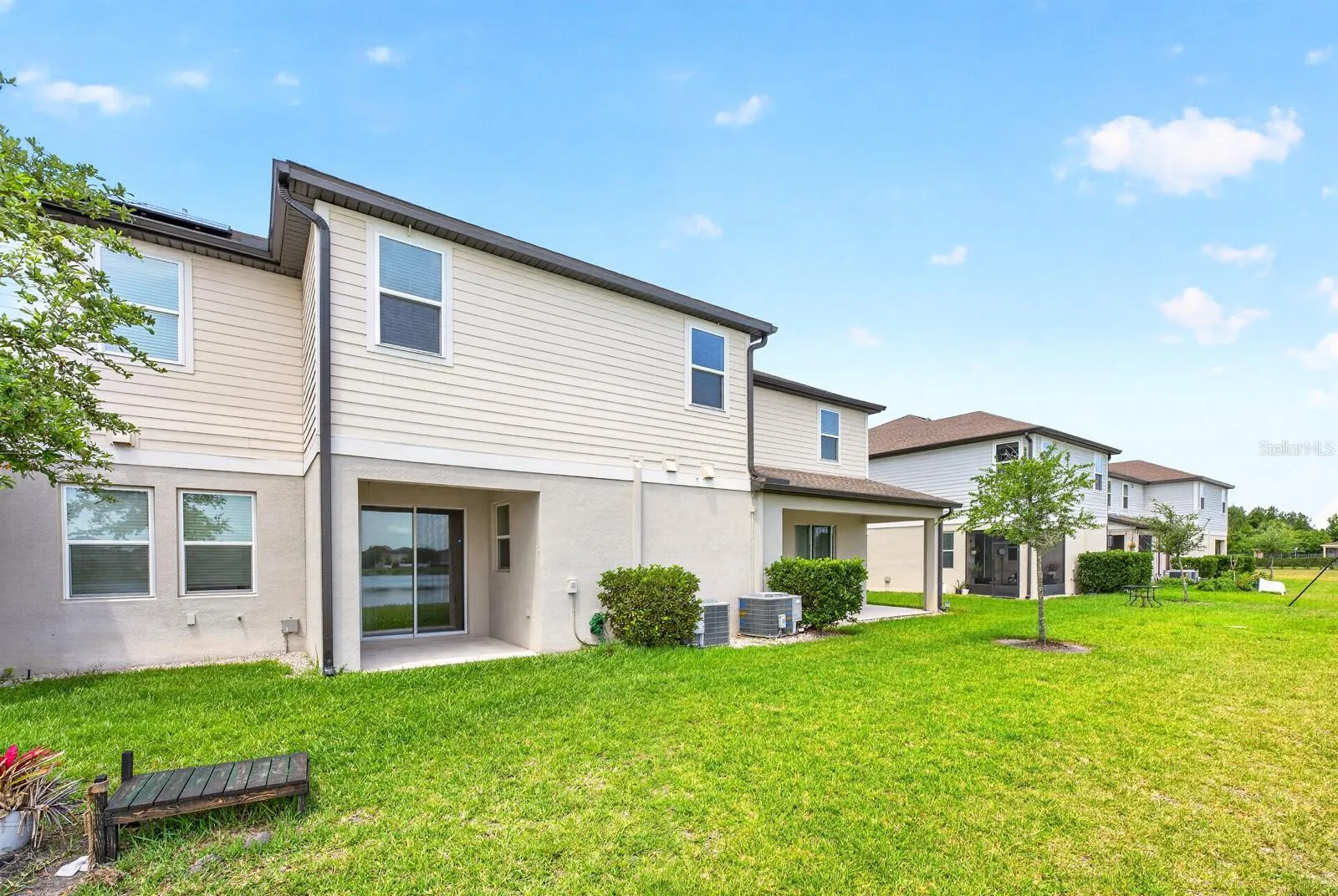 Covered lanai overlooks a nice green space with water views!