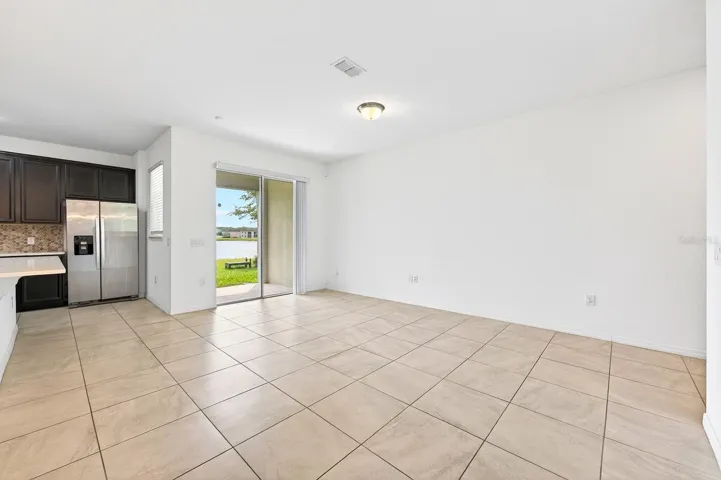 Living area has sliding glass doors that open up to the covered lanai.