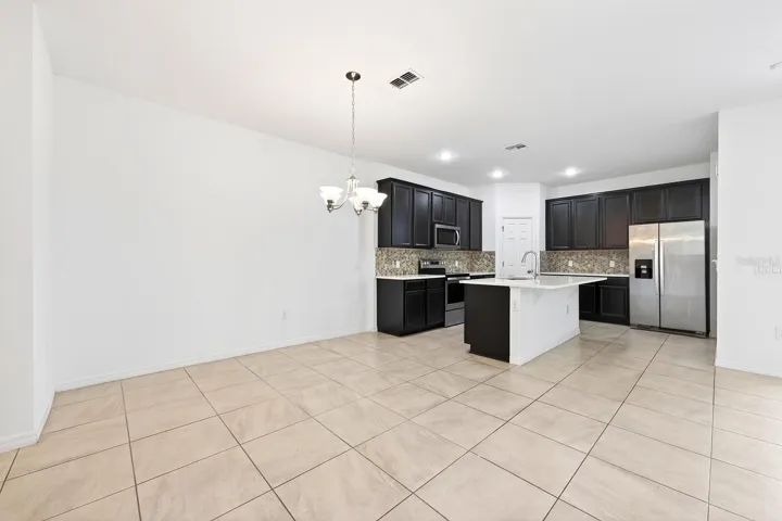 Kitchen is open to the living and dining areas.