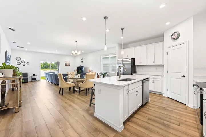 Kitchen flows seamlessly from dining to living, and out to the covered lanai.