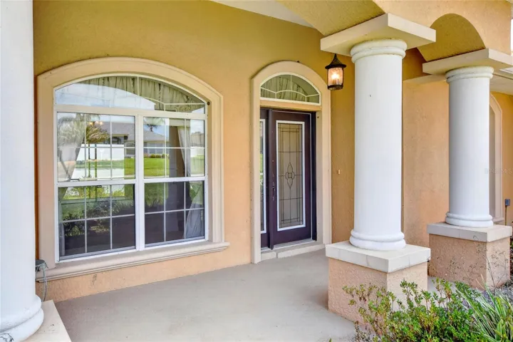 The covered front porch offers an easy approach, easing you into the home before the light and lake come into view.