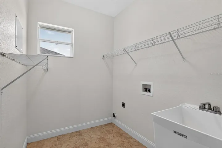 Just off the kitchen, the indoor laundry room is tucked in place, with natural light keeping it from feeling closed off.