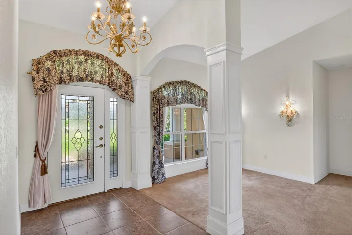 Turn back toward the entry and you’ll catch the details in the glass door and wide window, where the light first makes its way in.